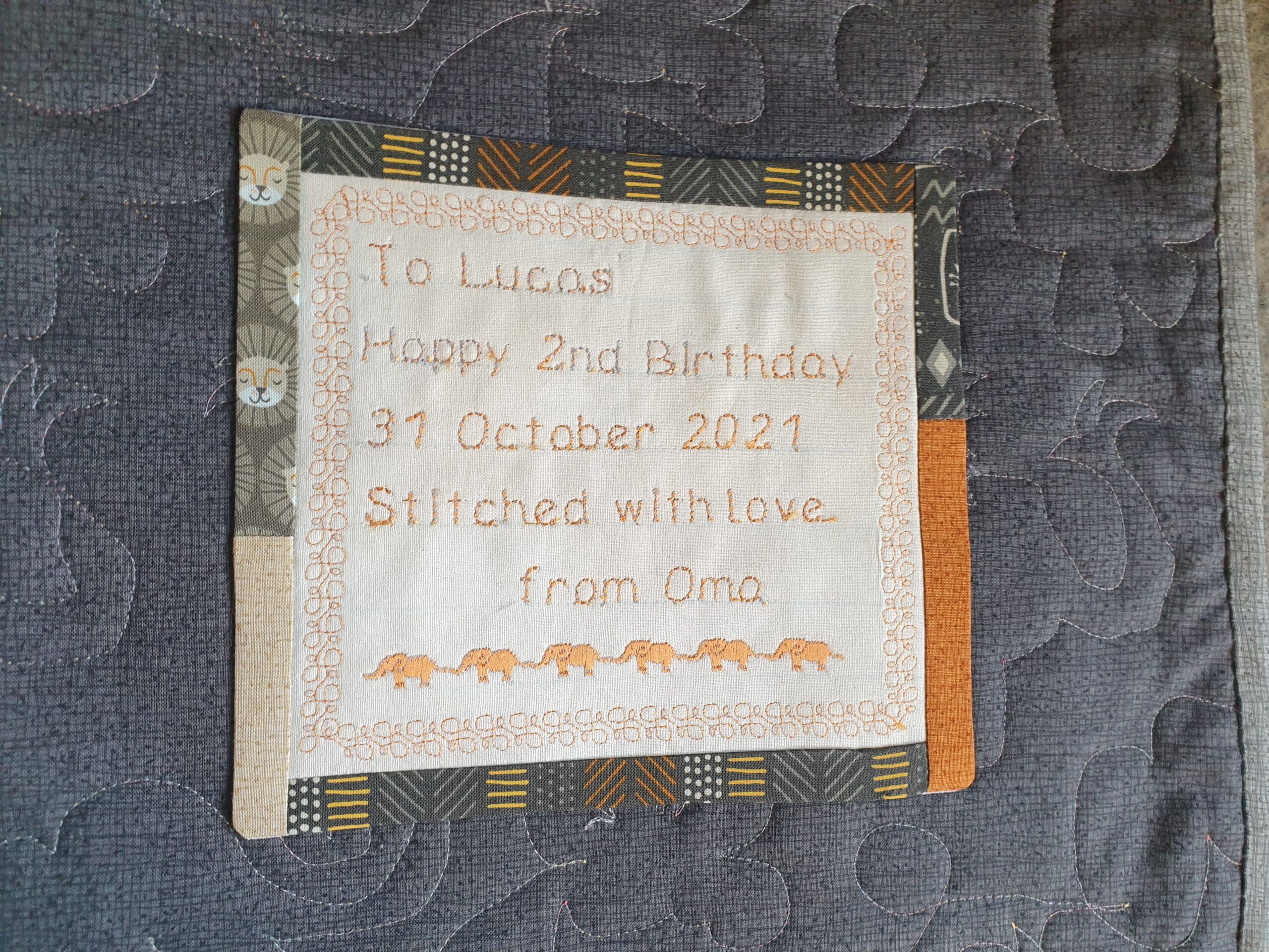 Hand-stitched custom quilt label with personalised message.